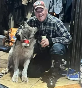 Cody Roberts poses with captive wolf he maimed and killed End Snowmobiling Over Wildlife