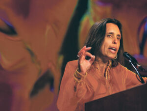 Winona LaDuke speaks at a conference. She is a trailblazer for women in conservation as we celebrate women's history month.