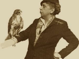 Rosalie Edge wearing a black suit hold a hawk on her arm. She is a trailblazer for women in conservation as we celebrate women's history month.